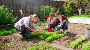 Mother and two girls work in the garden